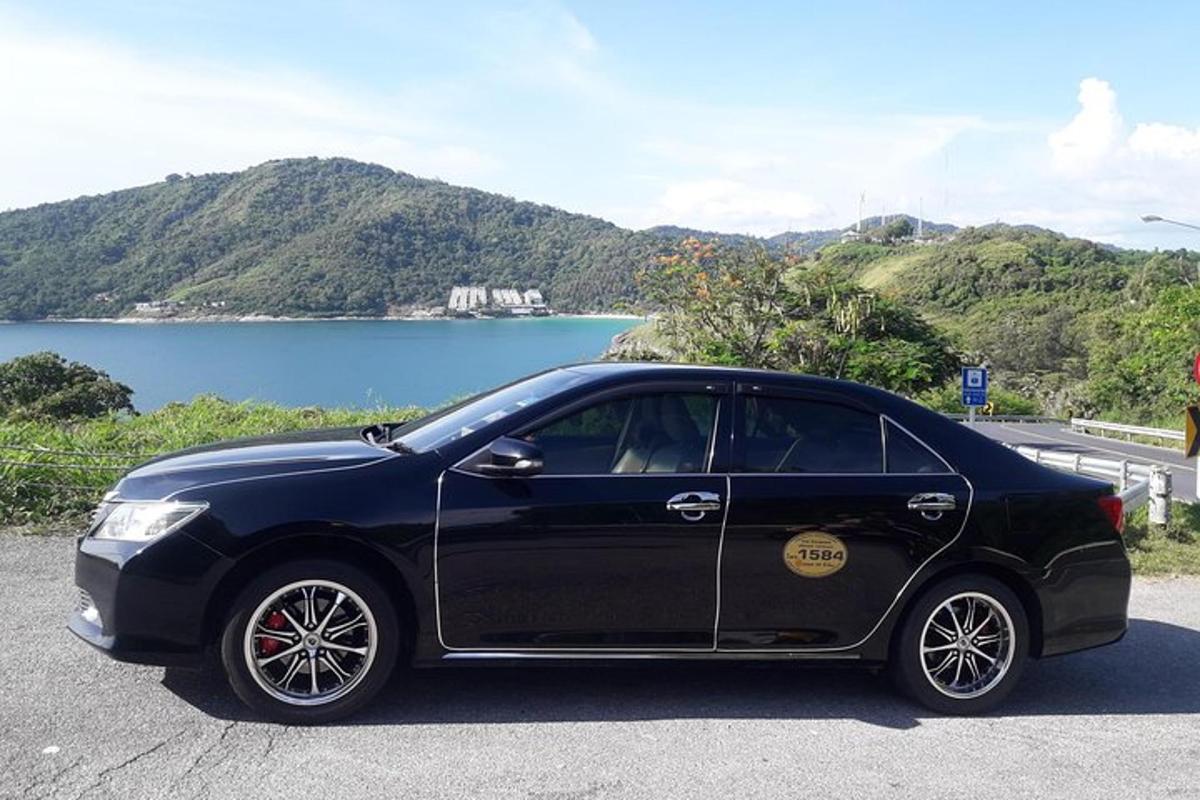 a black car parked on the side of a road