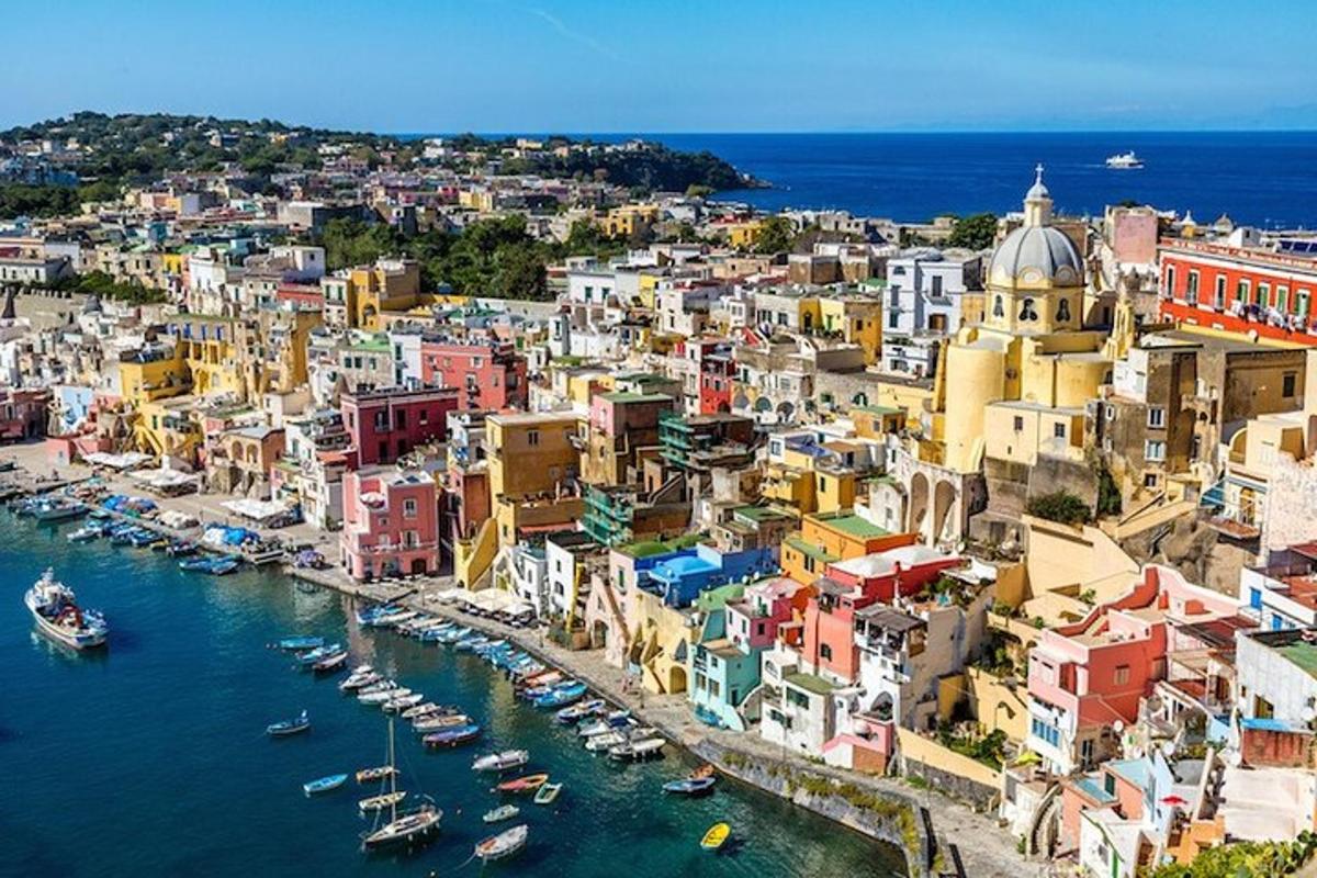 an aerial view of a city with boats in the water