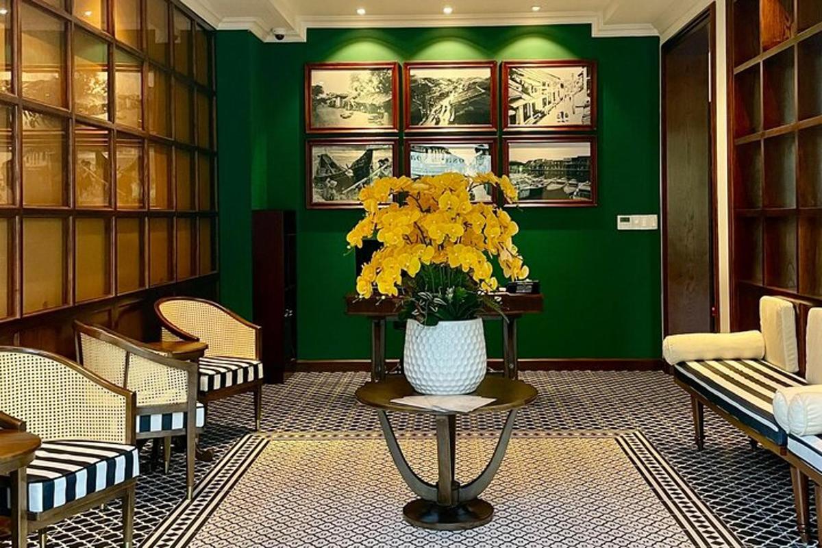 a green room with a vase of yellow flowers on a table