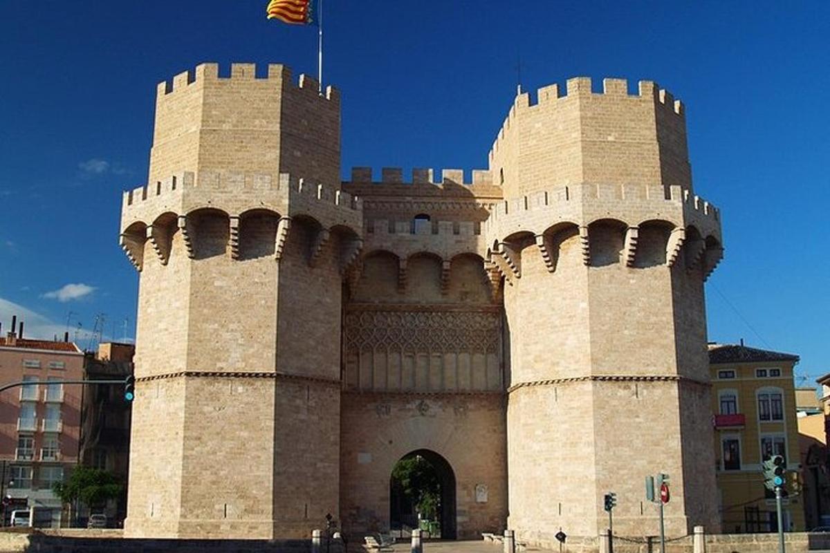 a building with two towers with a flag on top