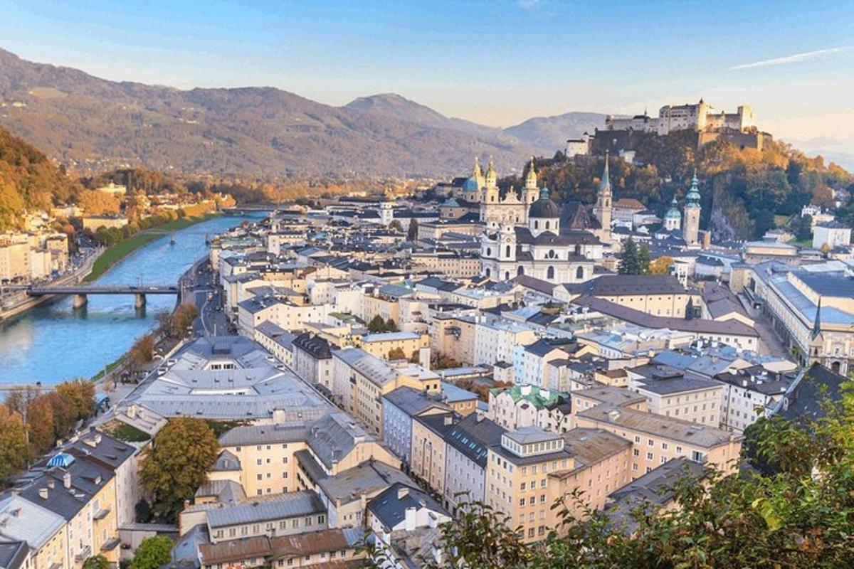 an aerial view of a city with a river and buildings