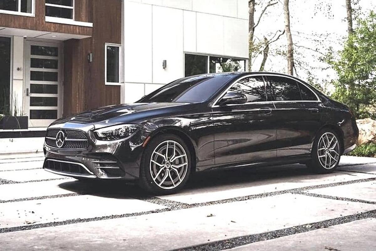 a black car parked in front of a house