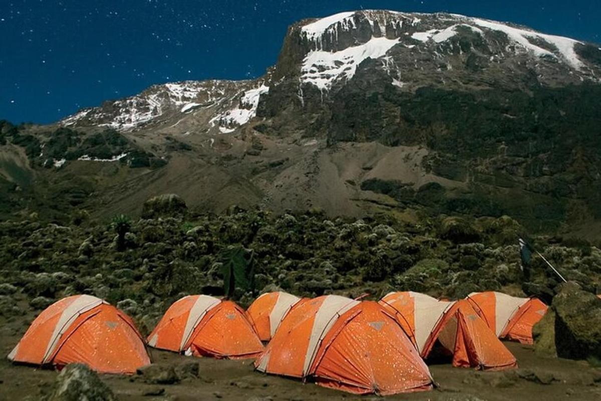 a group of tents in front of a mountain