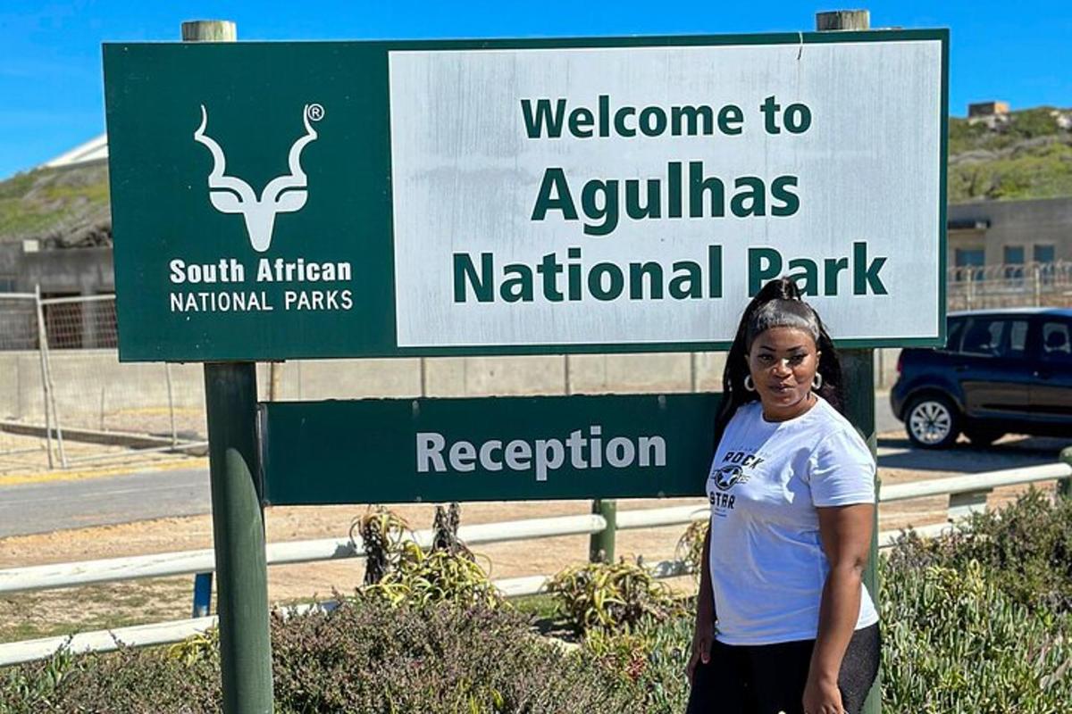 a woman is standing in front of a sign