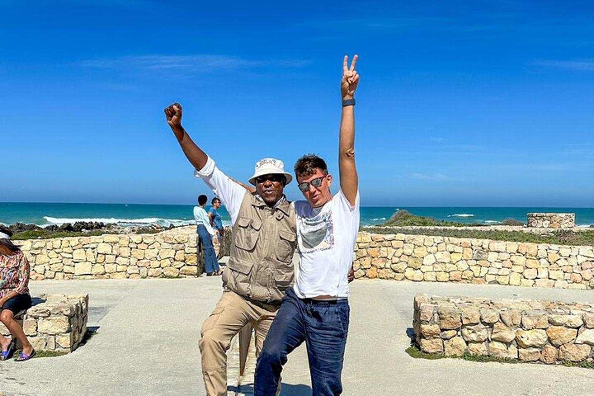 two men standing with their arms in the air