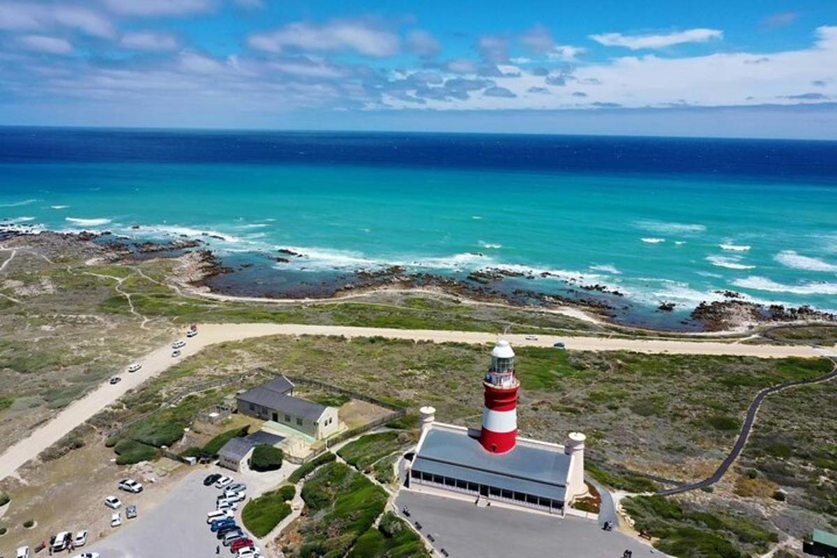 a lighthouse on top of a building next to the ocean