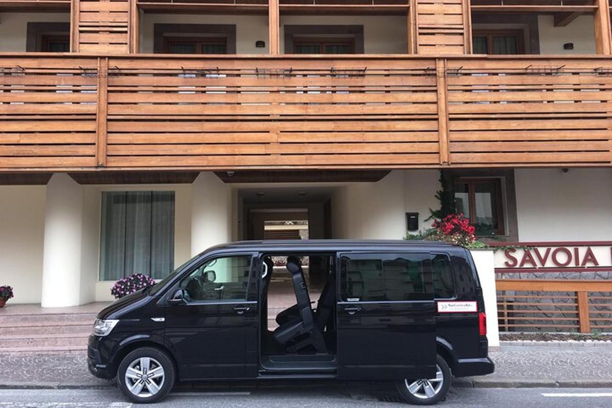 a small black van parked in front of a building