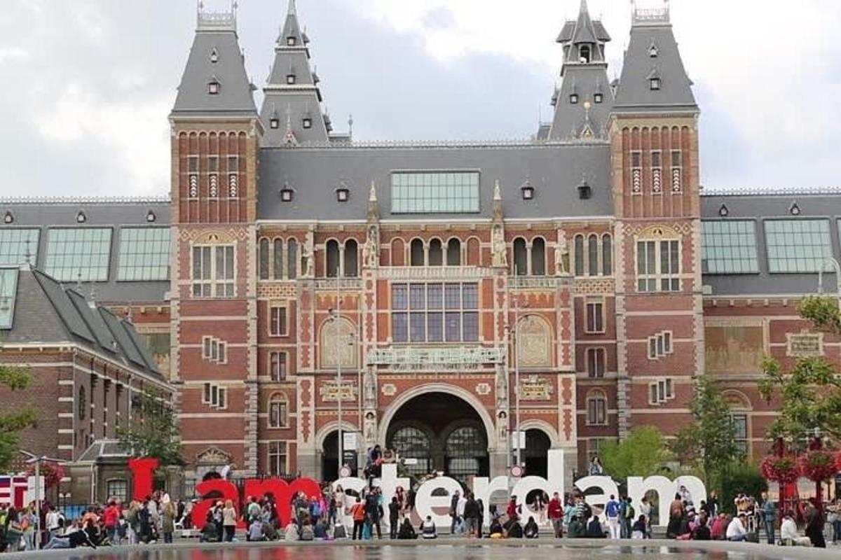 a large brick building with people standing in front of it