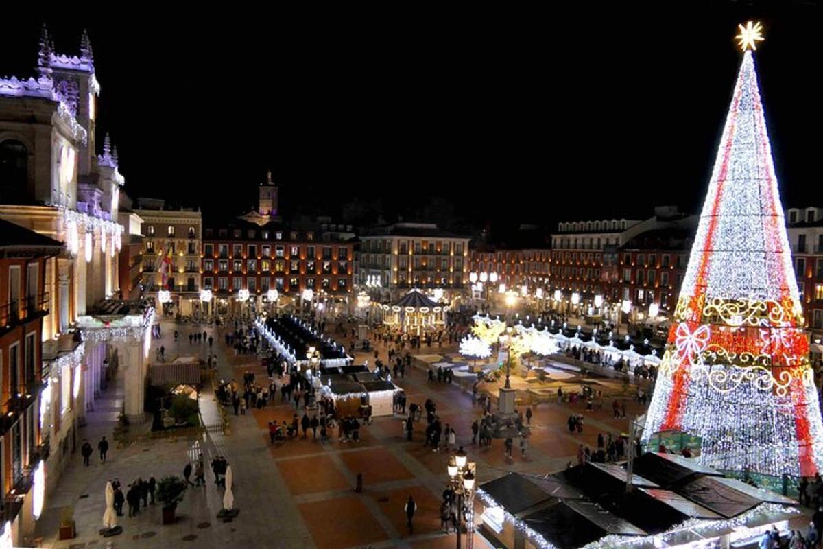 a large christmas tree in a city at night
