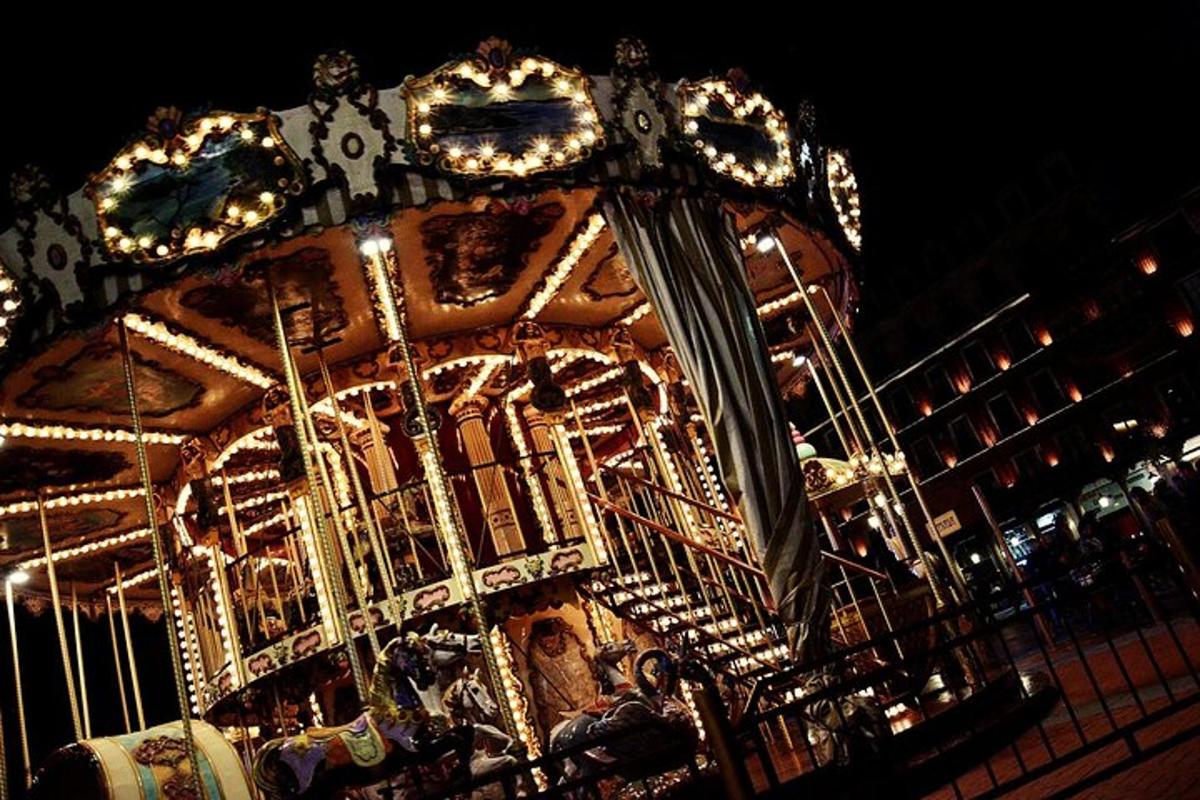 a merry go round is lit up at night