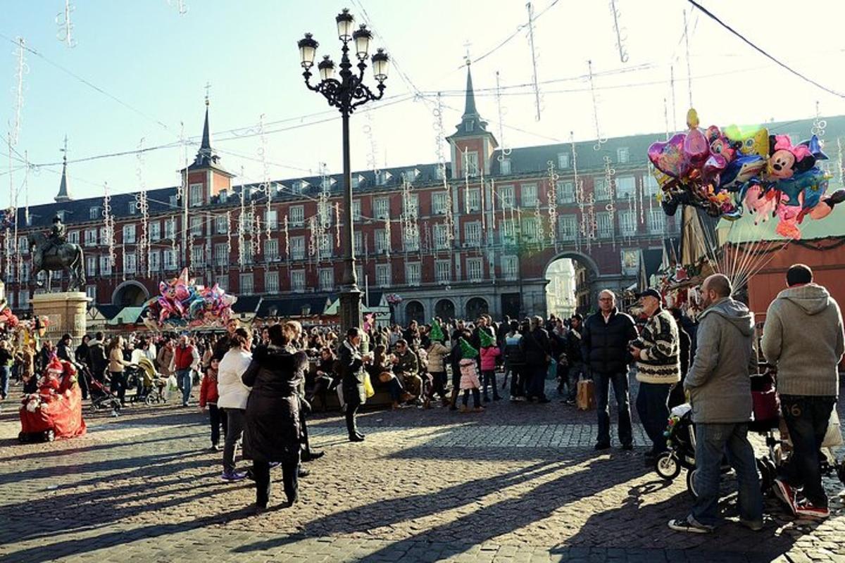 a crowd of people standing in a street in front of a building