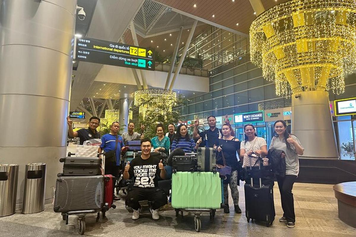 a group of people standing in an airport with luggage