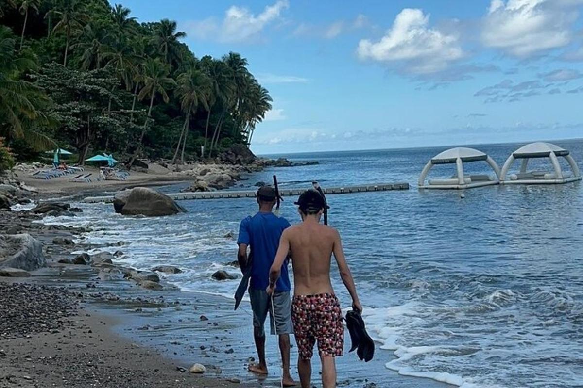 a man and woman walking on the beach