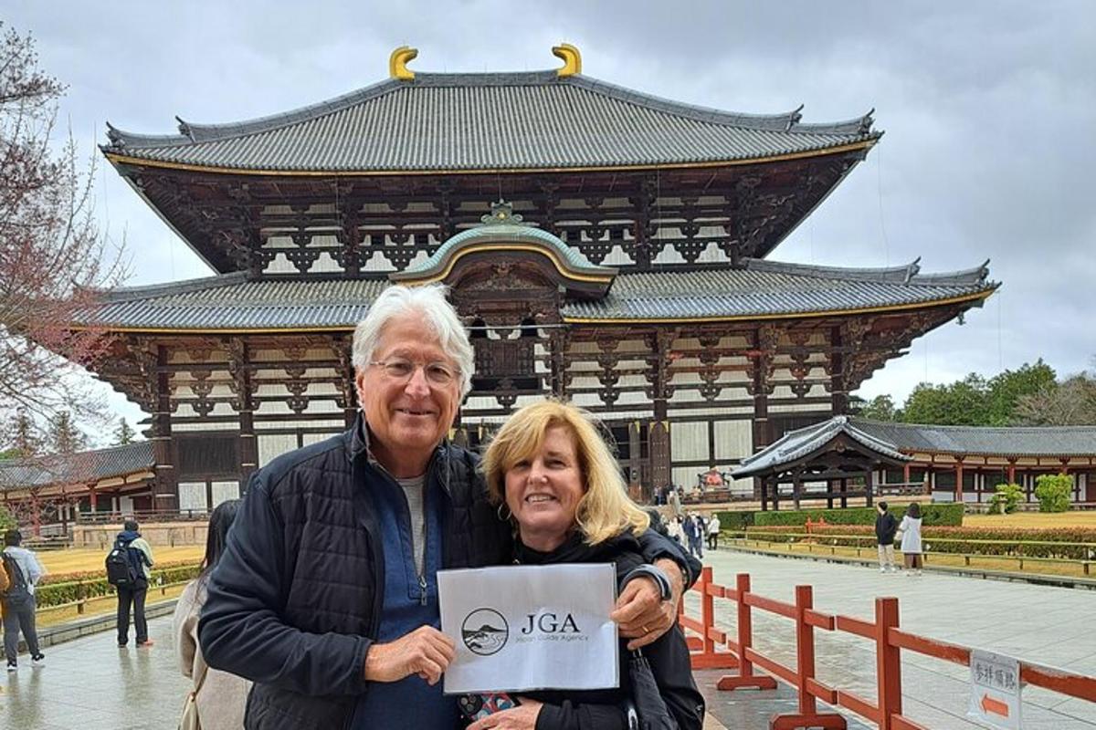 a man and a woman standing in front of a building