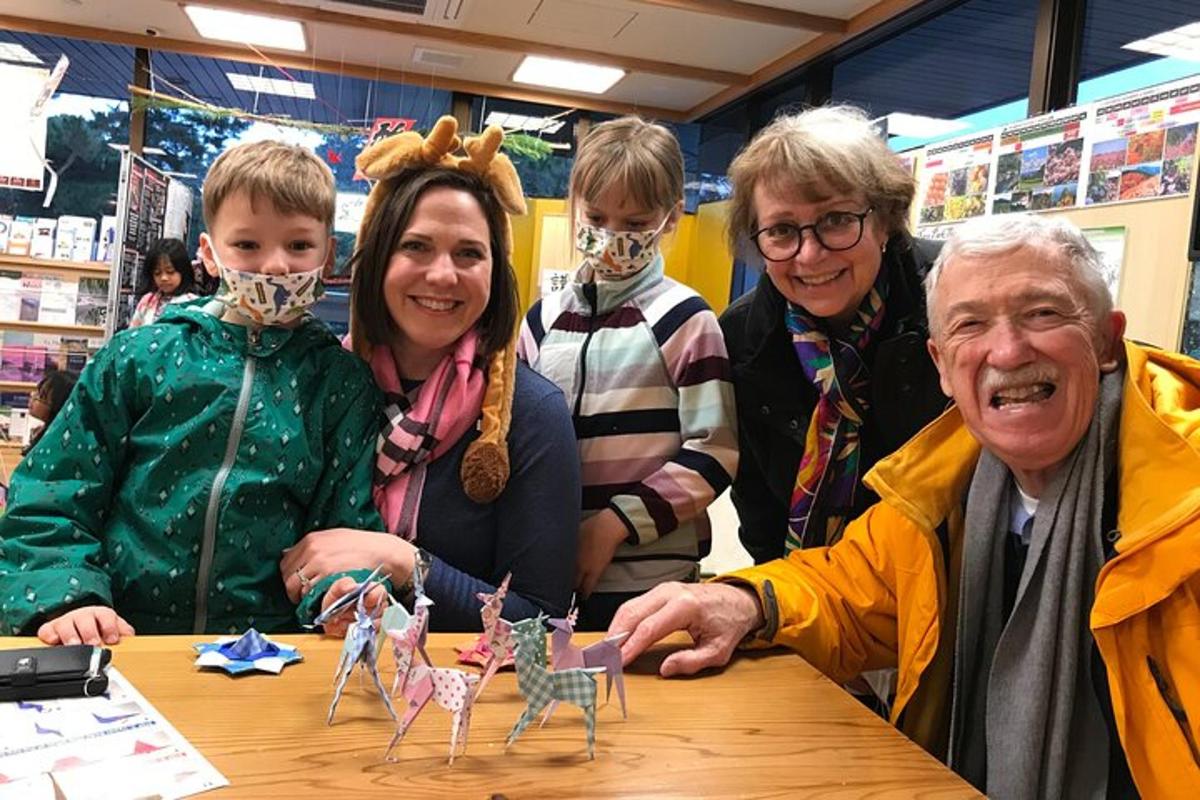 a group of people standing around a table with toy dolls