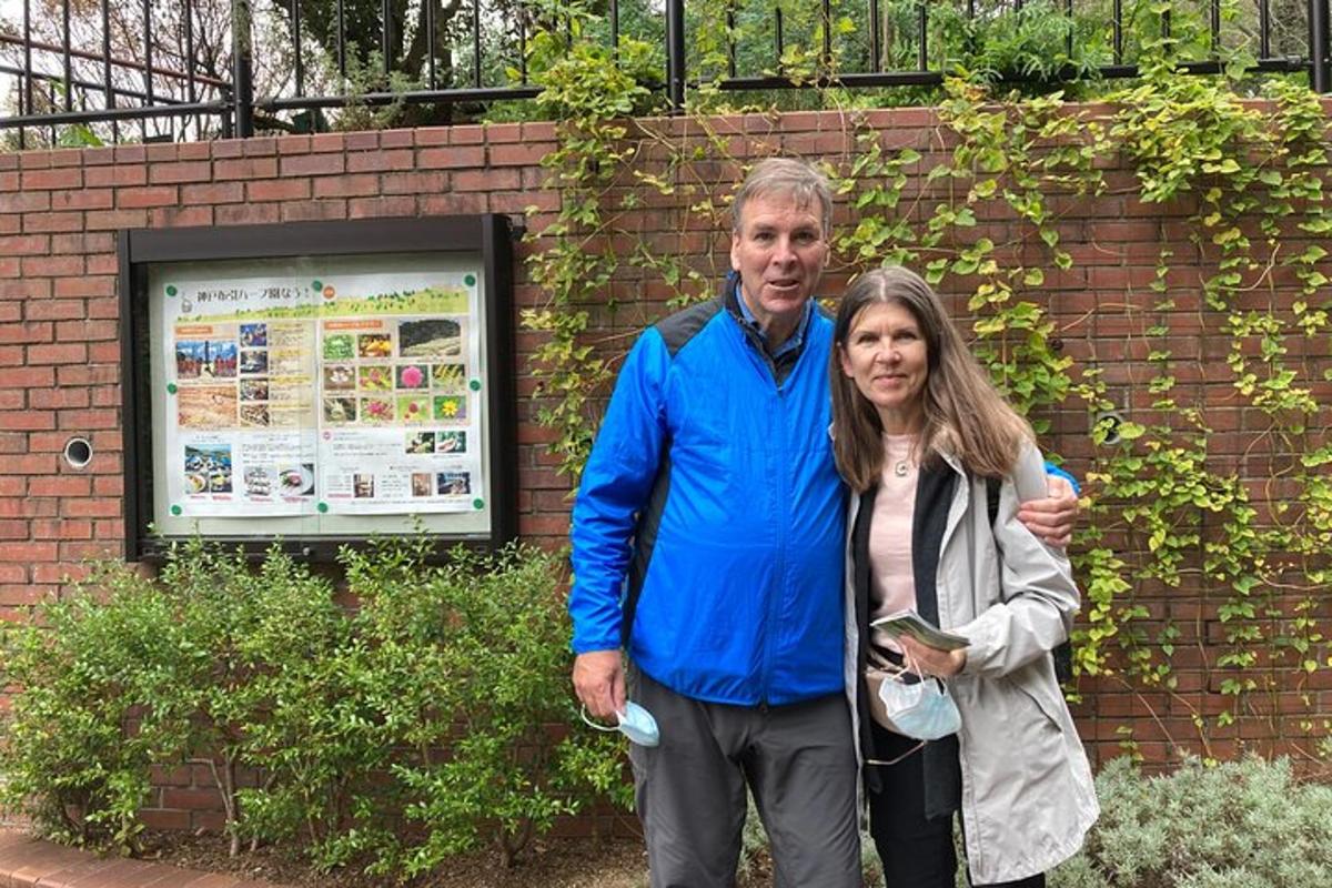 un uomo e una donna in piedi davanti a un muro di mattoni