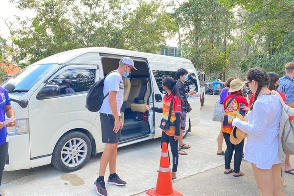 a group of people standing outside of a van