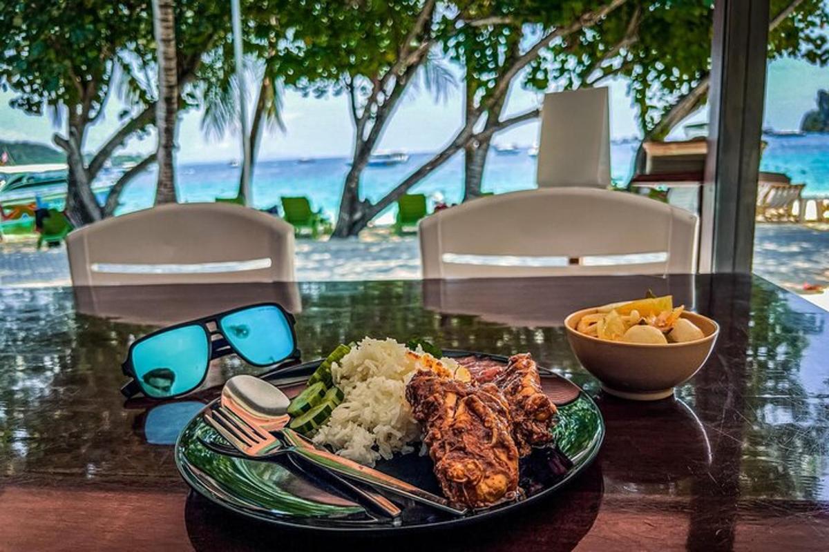 a table with a plate of food and a plate of rice