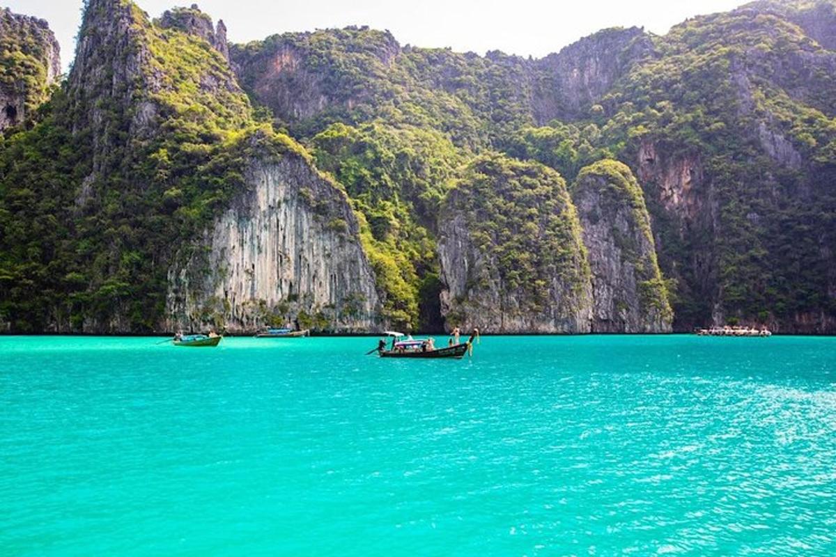 a group of boats in the water in front of mountains