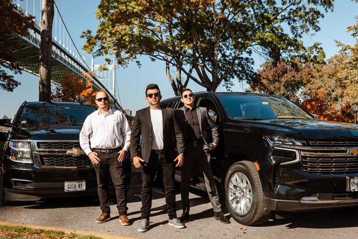 a group of three men standing next to a truck