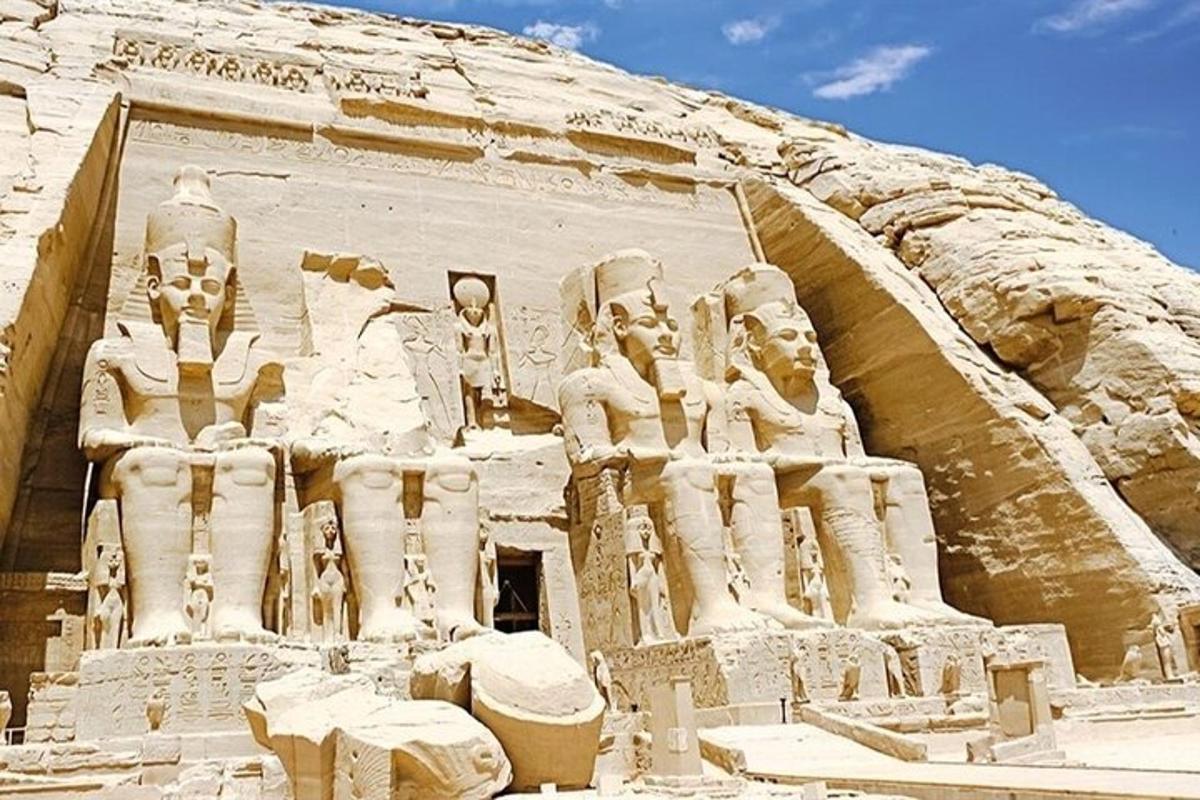 a large temple with statues on the side of a mountain