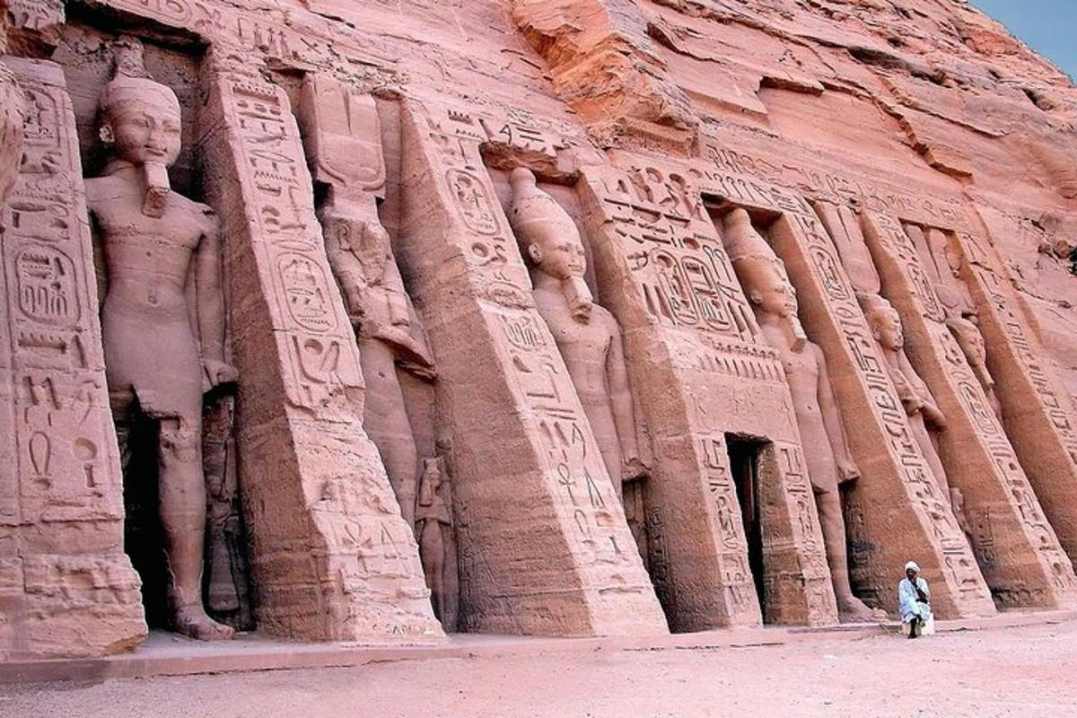 a person is standing in front of an ancient building