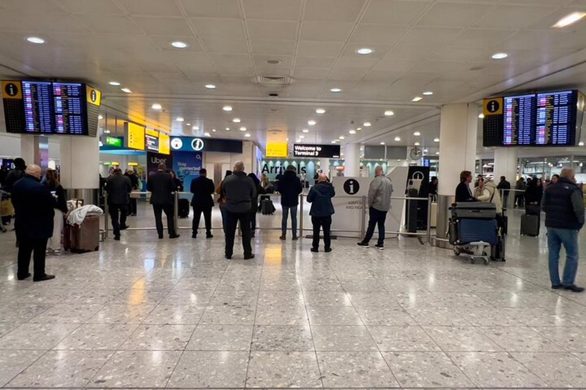a group of people standing in an airport terminal