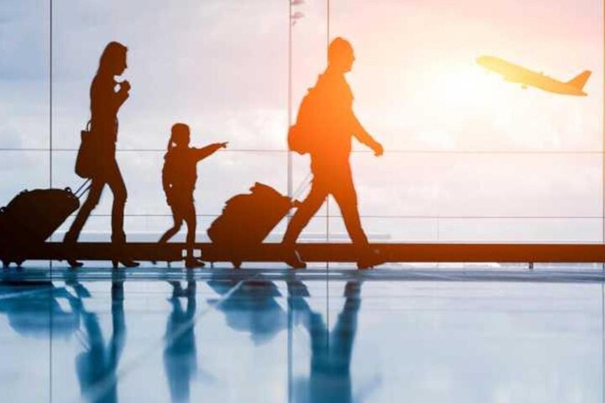 a group of people walking in an airport with luggage