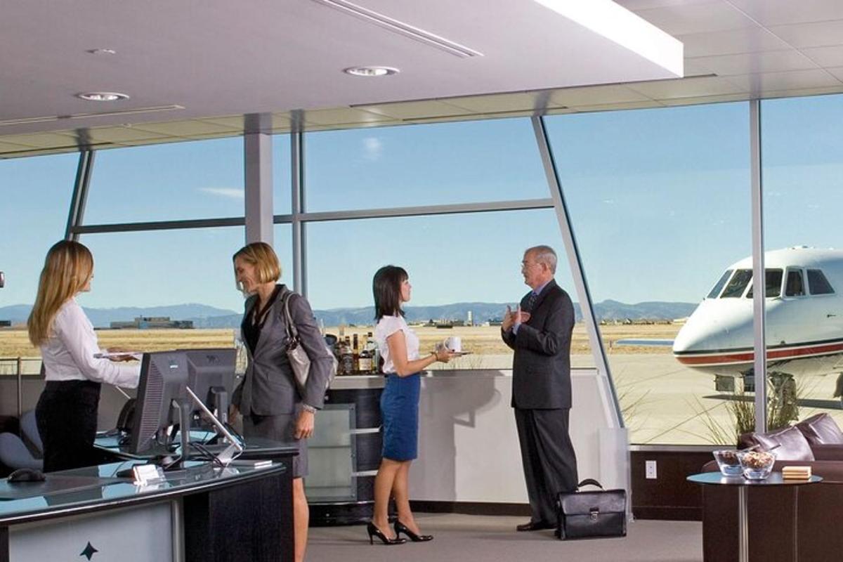 a group of people standing at an airport with an airplane