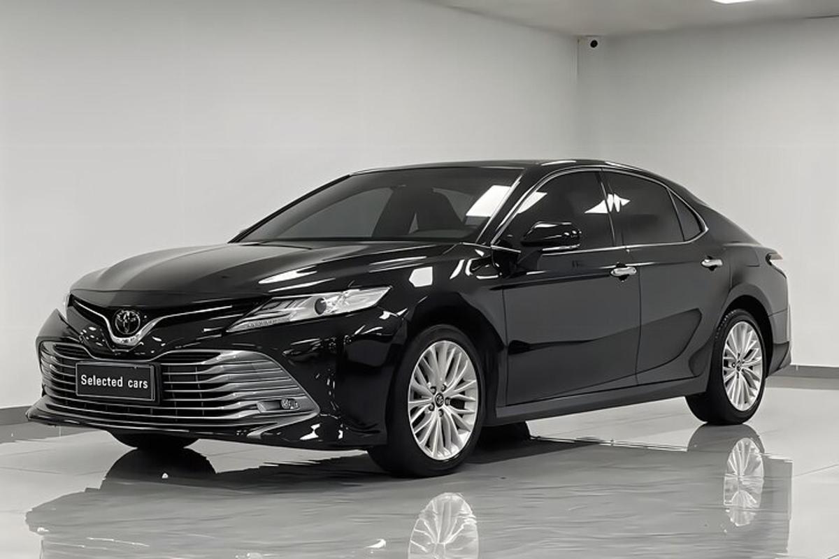 a black car is parked in a room