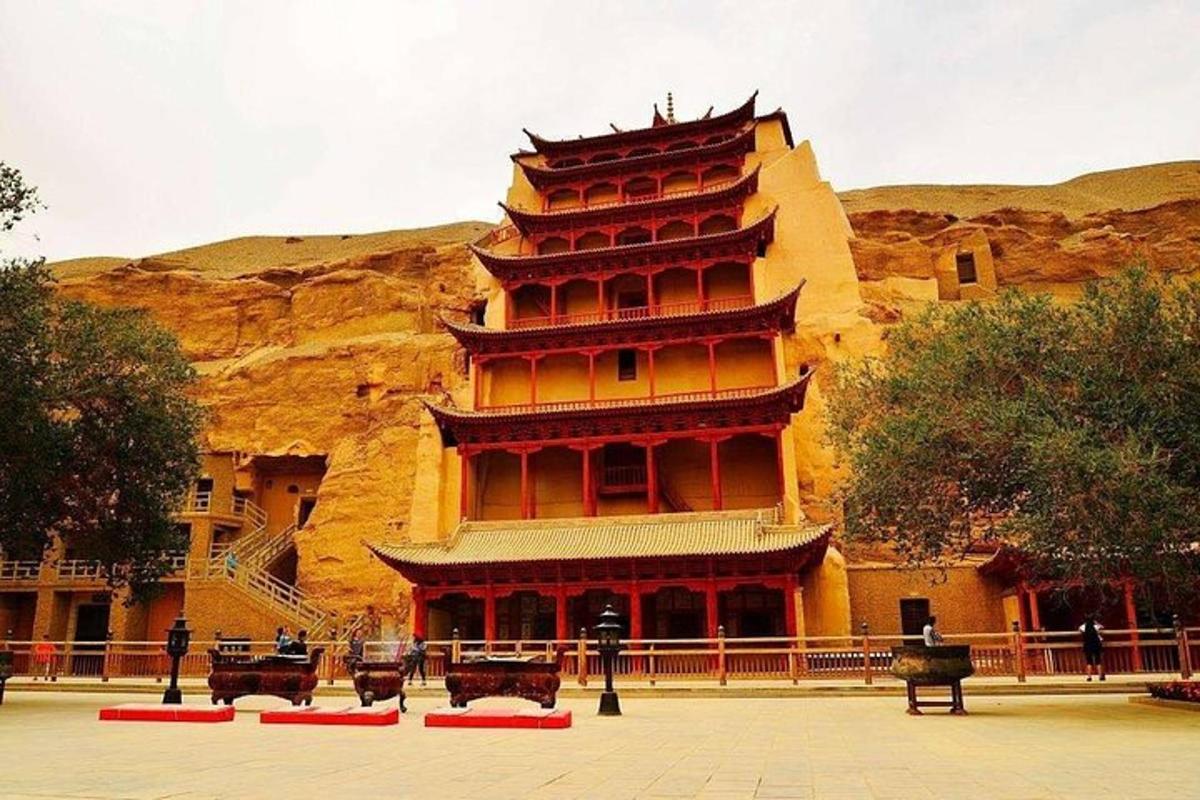 a large building with a mountain in the background