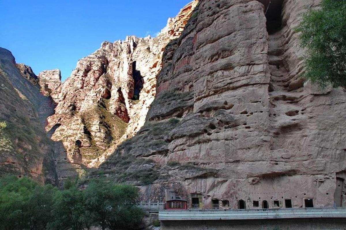 a rocky mountain with a bridge in front of it