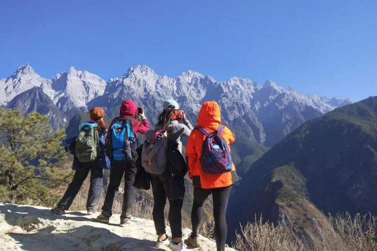 a group of people standing on top of a mountain