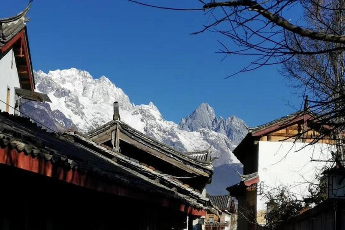 a snow covered mountain in front of a building