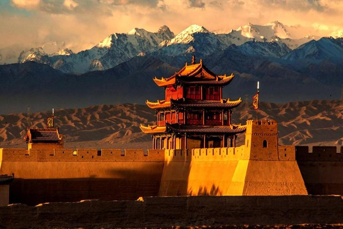 a castle with a tower in front of a mountain