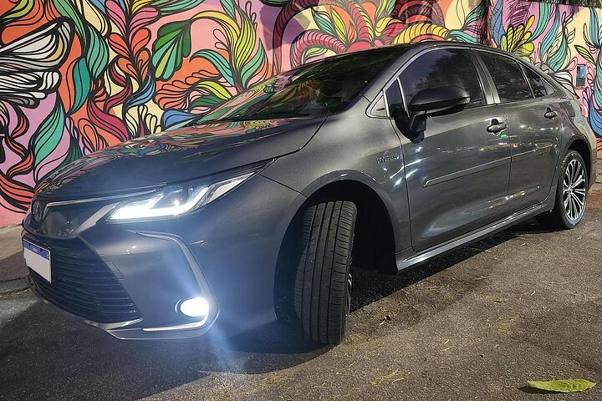 a silver car parked in front of a wall