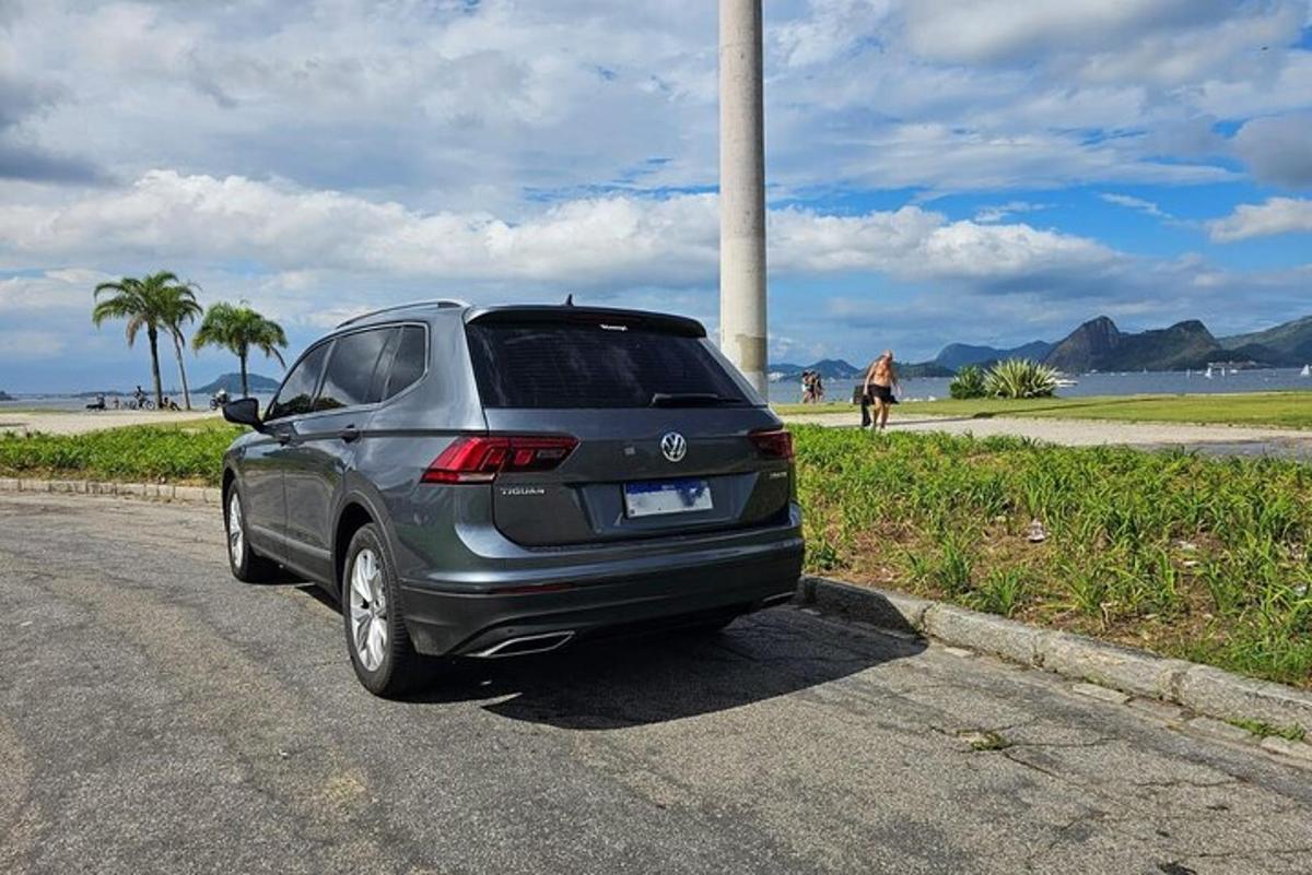 a car parked on the side of a road near the beach