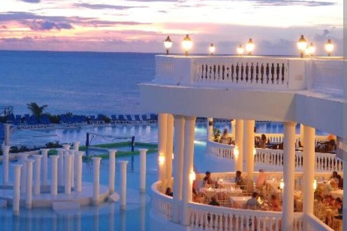 a hotel with a view of the ocean at dusk