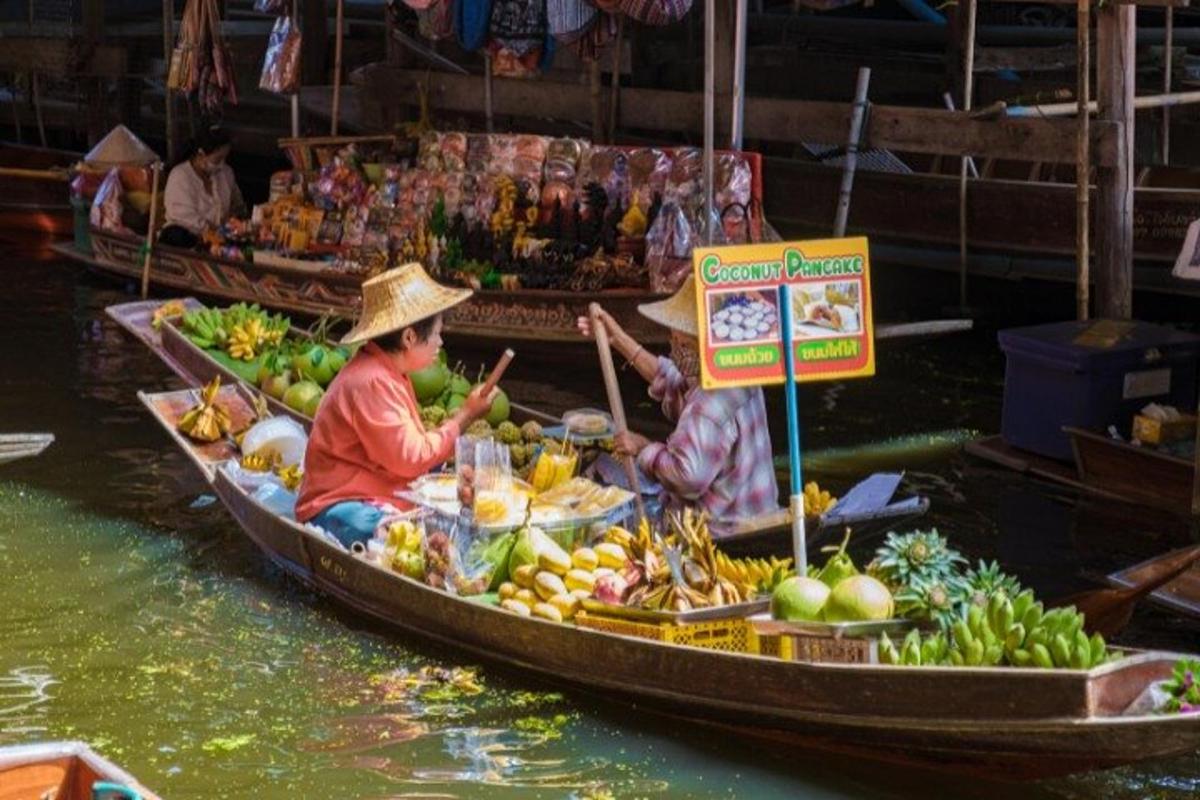 two people in a boat filled with fruit and vegetables