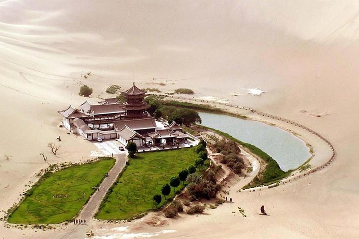 a large building on a island in the sand