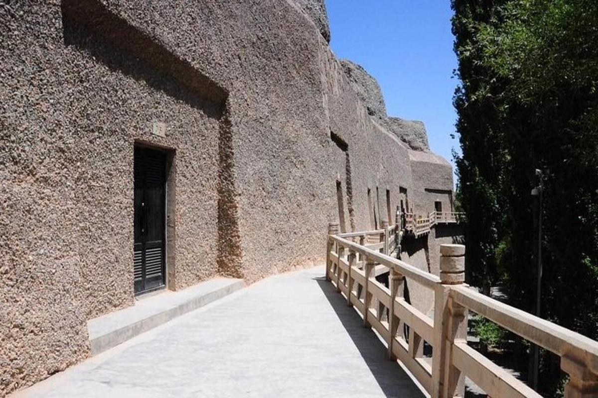 a building with a walkway next to a fence