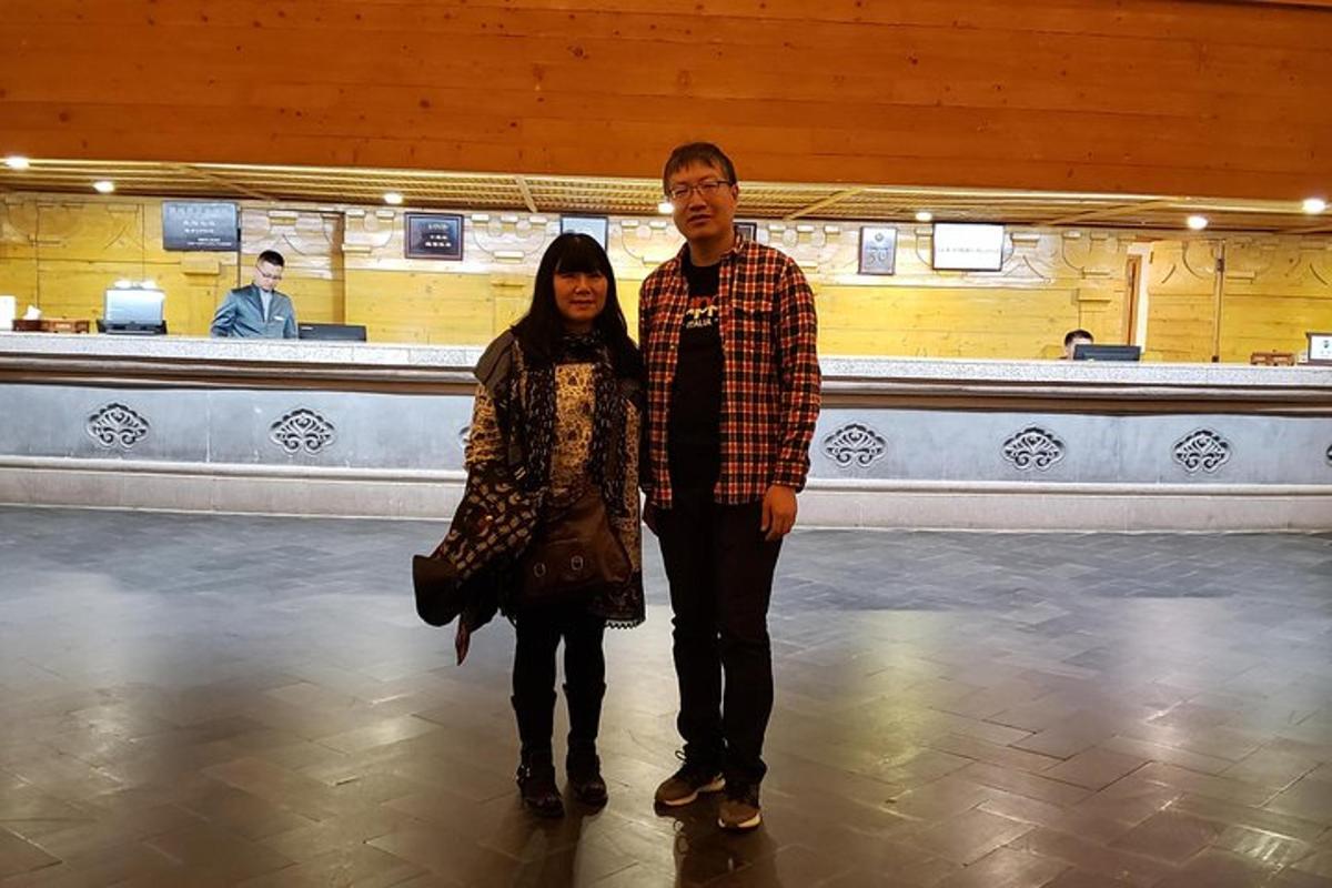 a man and a woman standing in a bowling alley
