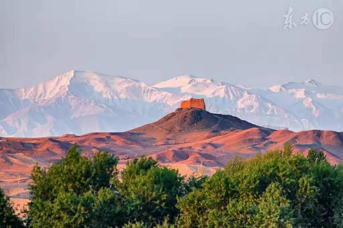 a mountain with a red tower on top of it