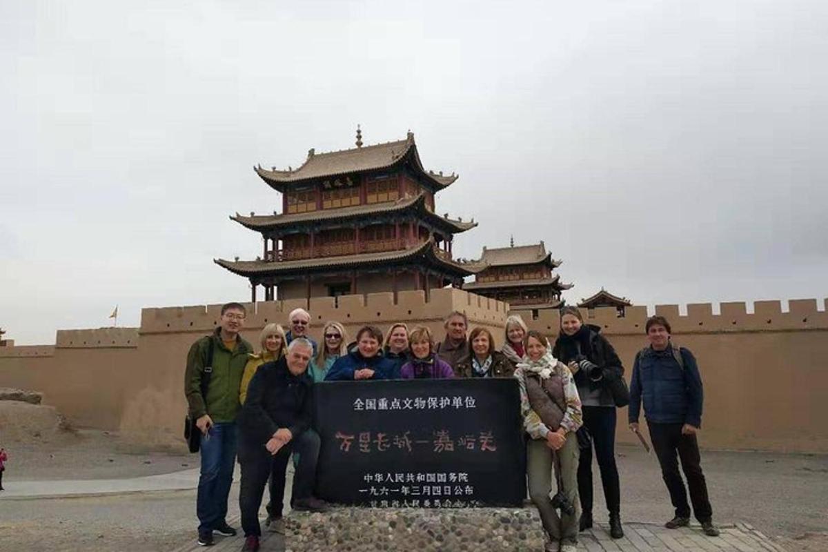 a group of people standing around a sign in front of a building
