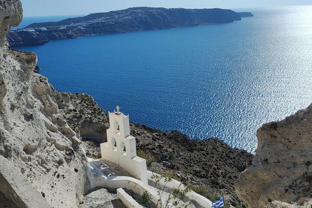a white chapel on a cliff near the ocean