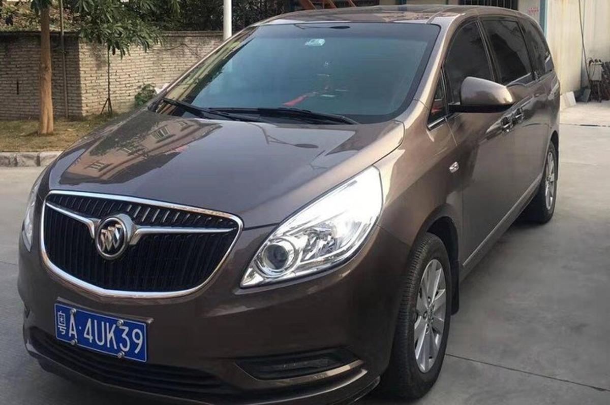 a brown car parked in a parking lot