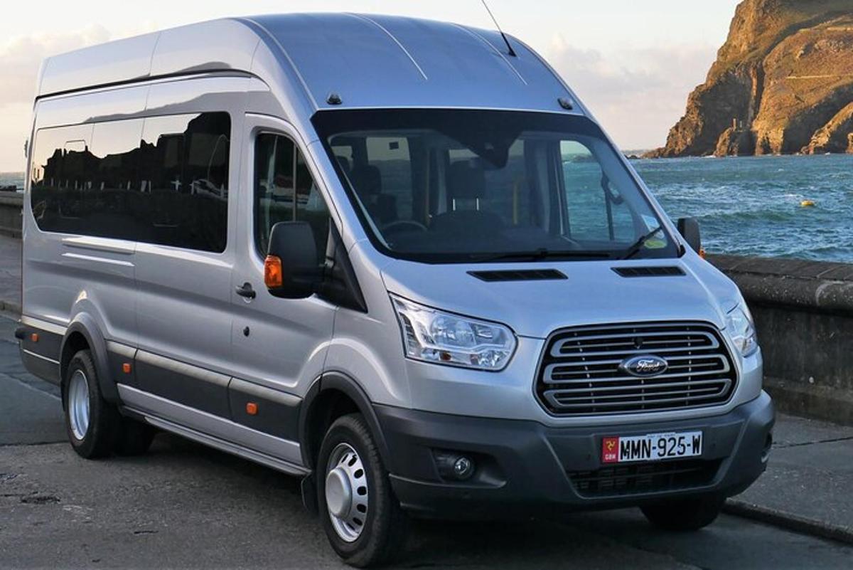 a silver van parked next to a body of water
