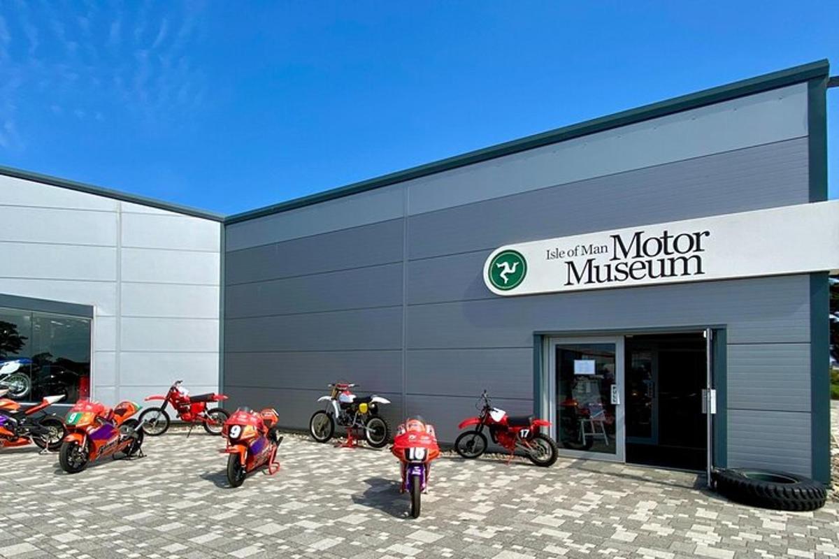a group of motorcycles parked outside of a motor museum