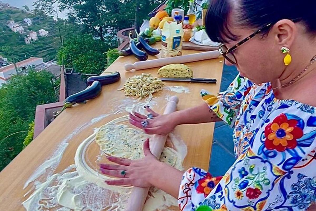 a woman making a pizza on a table