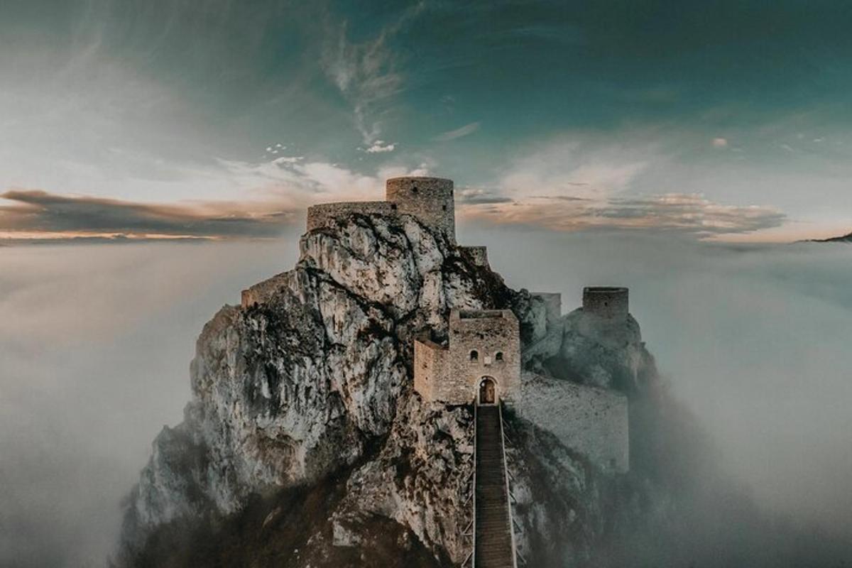 a castle on top of a mountain in the clouds